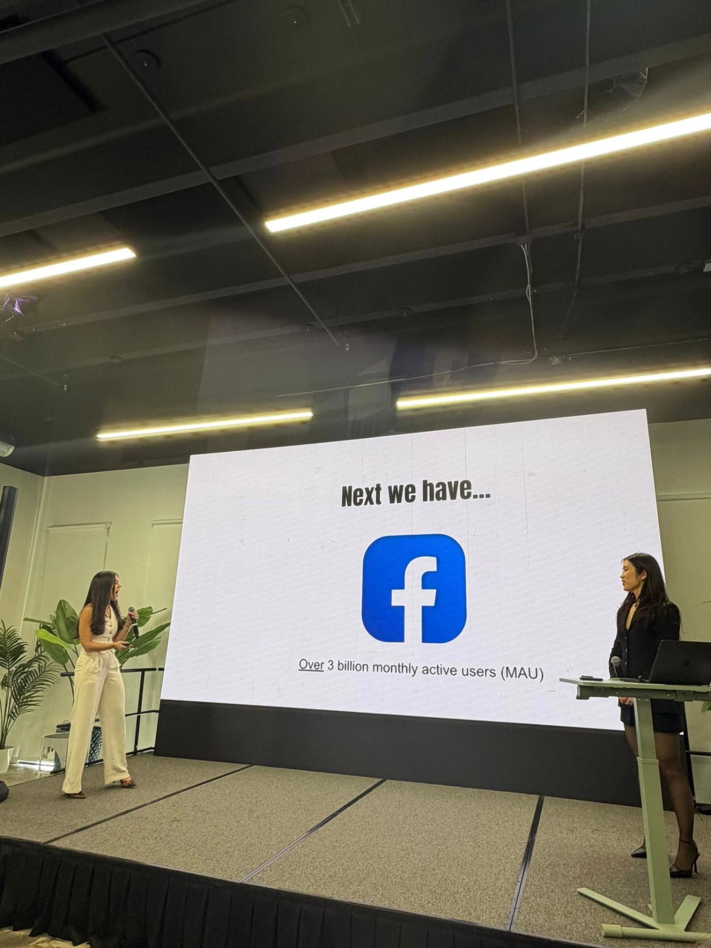Camila and Stephy presenting on stage